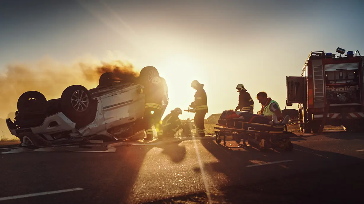 Emergency responders assist crash victims at a serious car accident scene