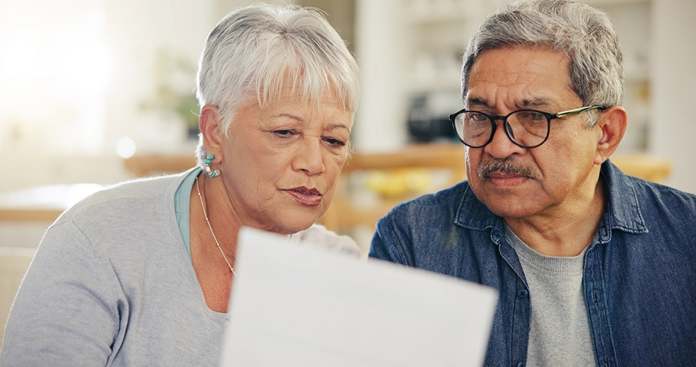 senior couple reading document Senior couple reading a document