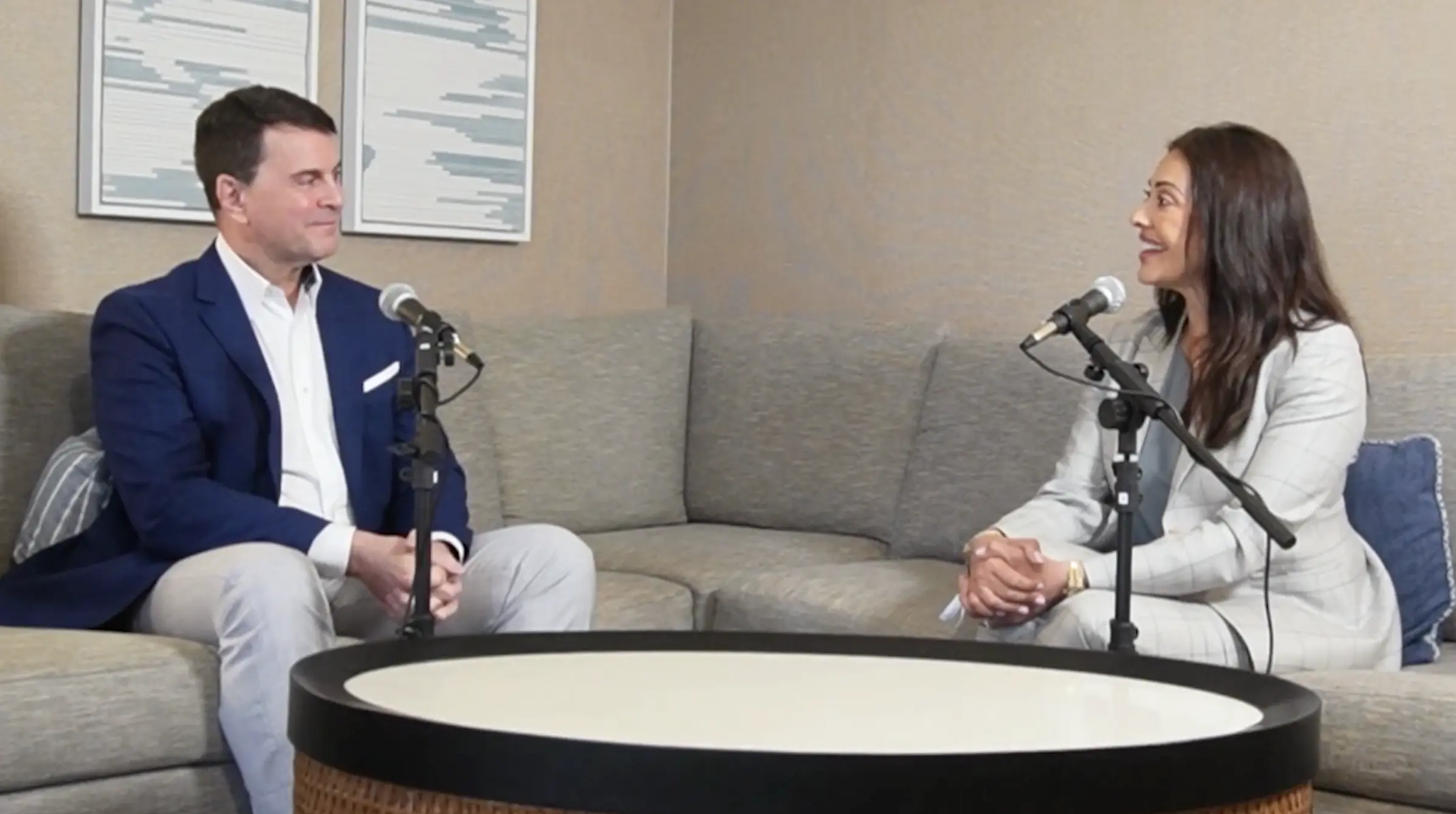 Cristina Perez and Alejandro Blanco sit on a couch during a podcast interview for Verdicts & Vogue Episode 6, discussing catastrophic injury and Camp Lejeune litigation