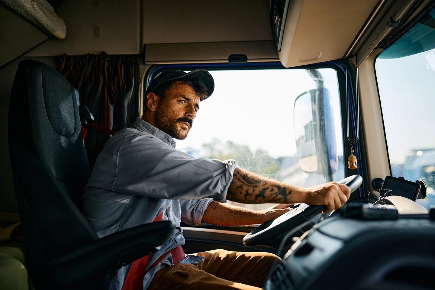 Truck driver focused while steering a commercial semi-truck on an Arizona highway.