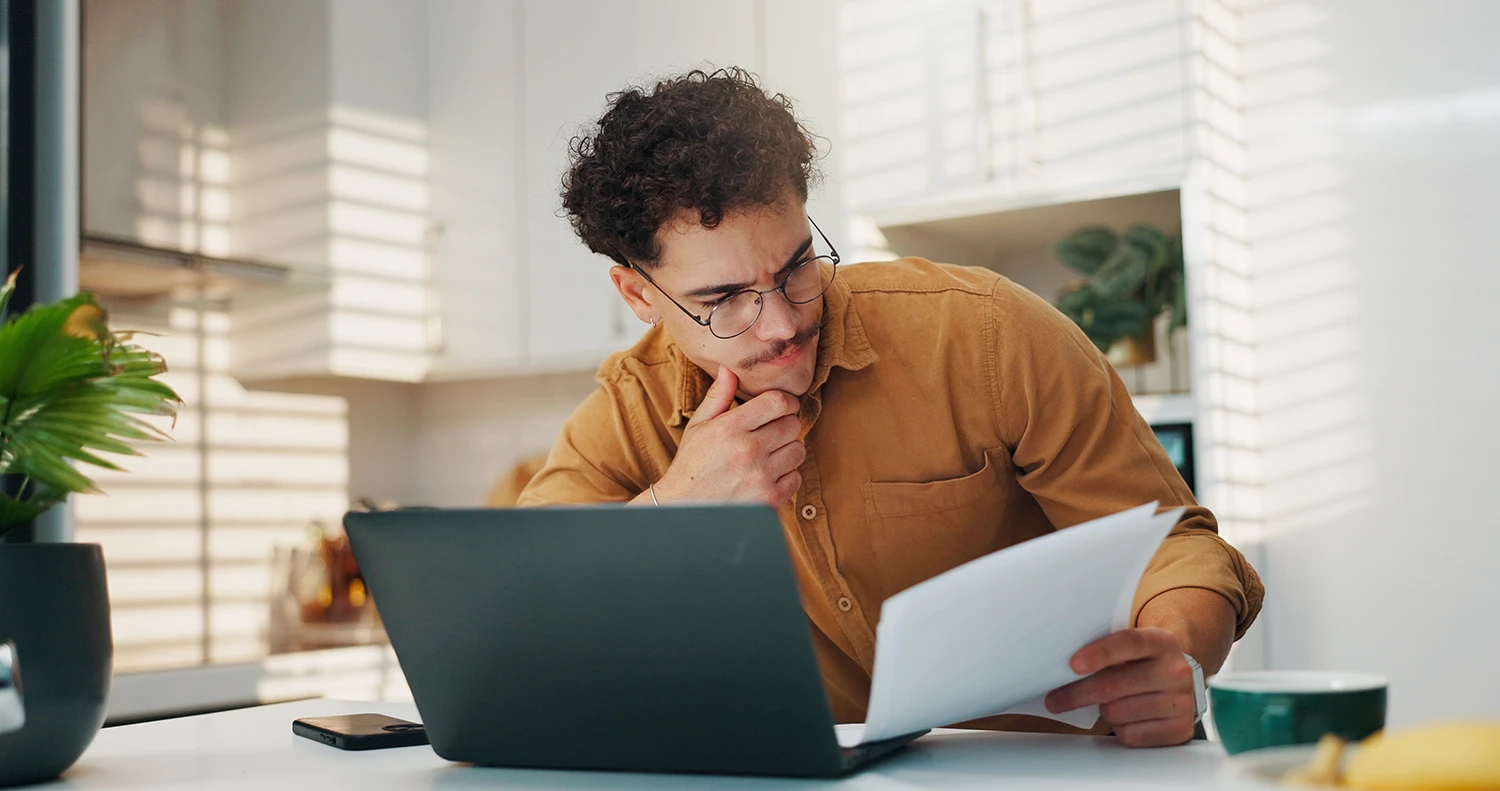 Man reviewing legal documents at home while deciding whether to handle a personal injury claim alone or hire a lawyer