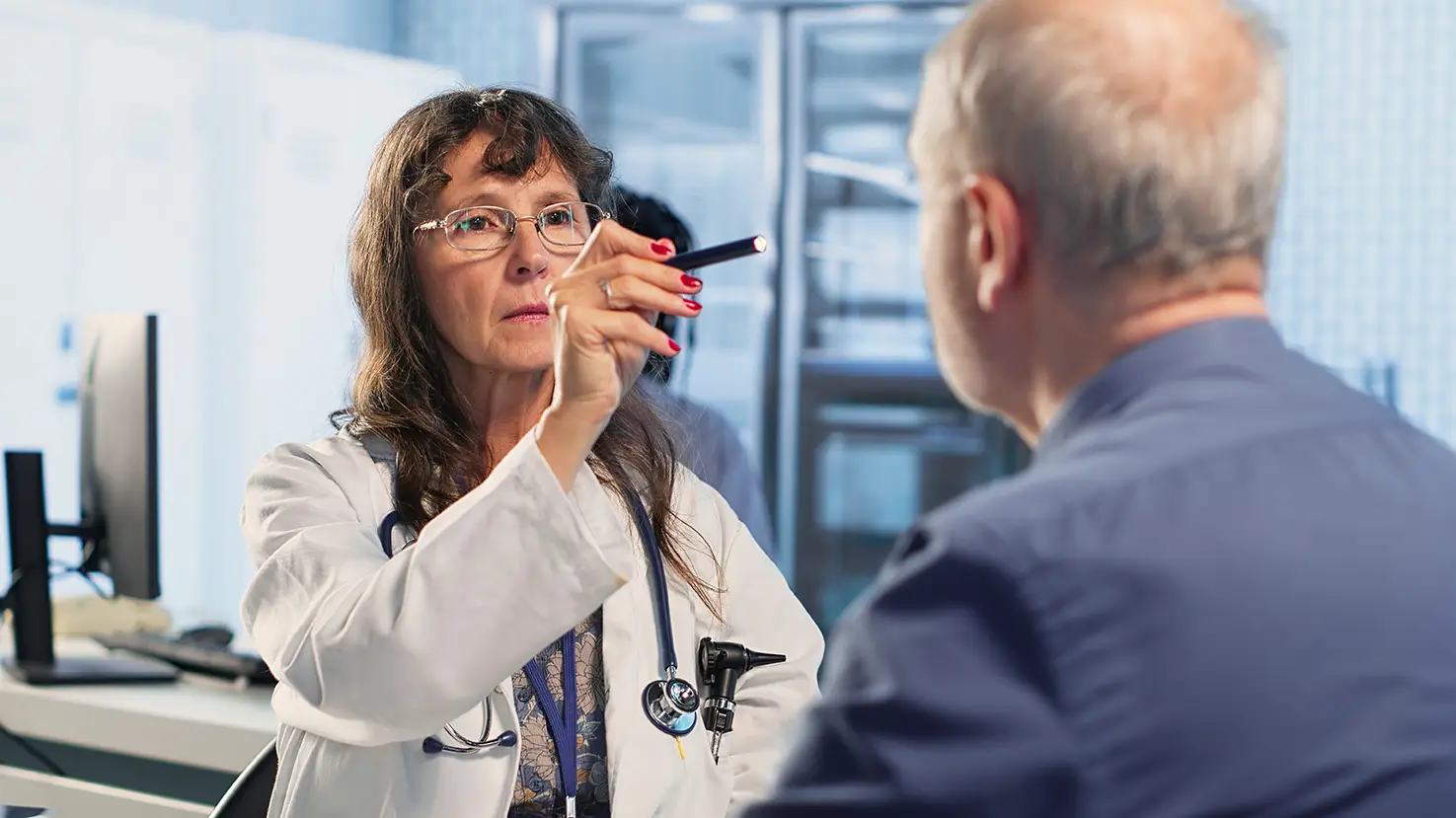 Doctor performing a neurological examination on a patient with possible concussion symptoms