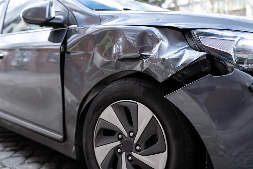 Gray car with front-end damage after a collision in Arizona