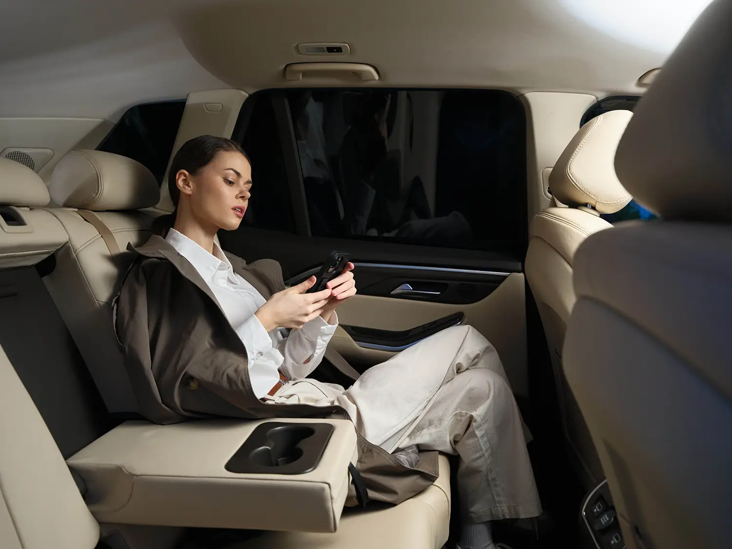 Passenger wearing a seat belt in the back seat of a vehicle