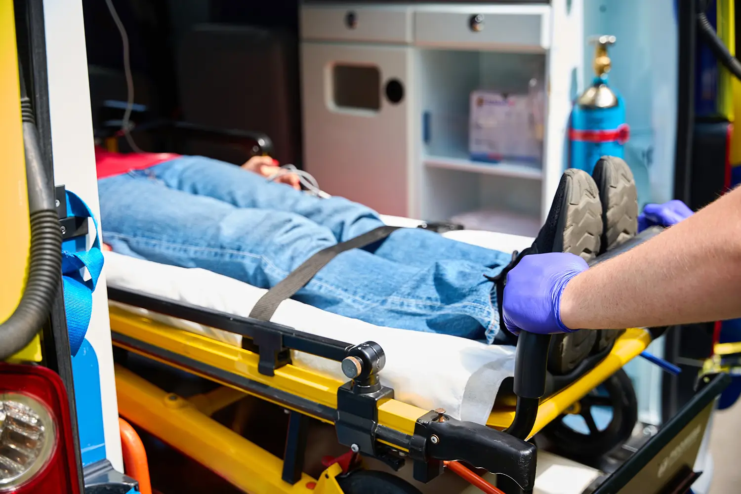Car accident injury patient being transported by ambulance for medical treatment